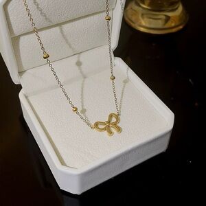 Cute gold tone bow necklace, stainless steel